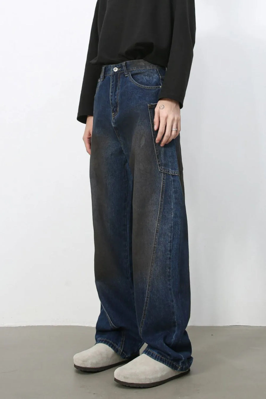 Faded panel wide-leg denim trousers in medium wash with a relaxed fit.
