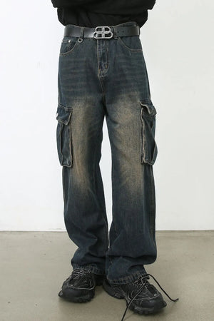 Dark wash wide-leg cargo jeans with faded details and utility pockets.
