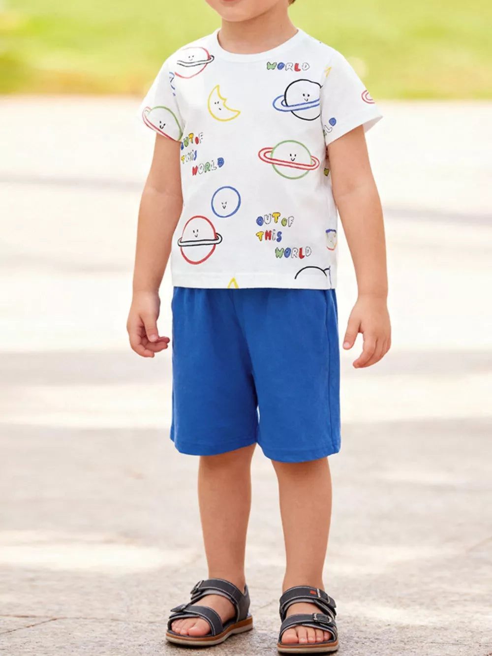 Children's white short sleeve tee with planet print and blue shorts set.