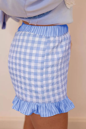 Light blue gingham cotton shorts with drawstring waist and ruffle hem.