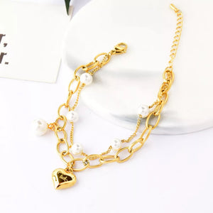 Synthetic Pearl, 18K Gold-Plated, Titanium Steel Care instructions: Avoid wearin bracelet in Gold with jewelry silhouette
