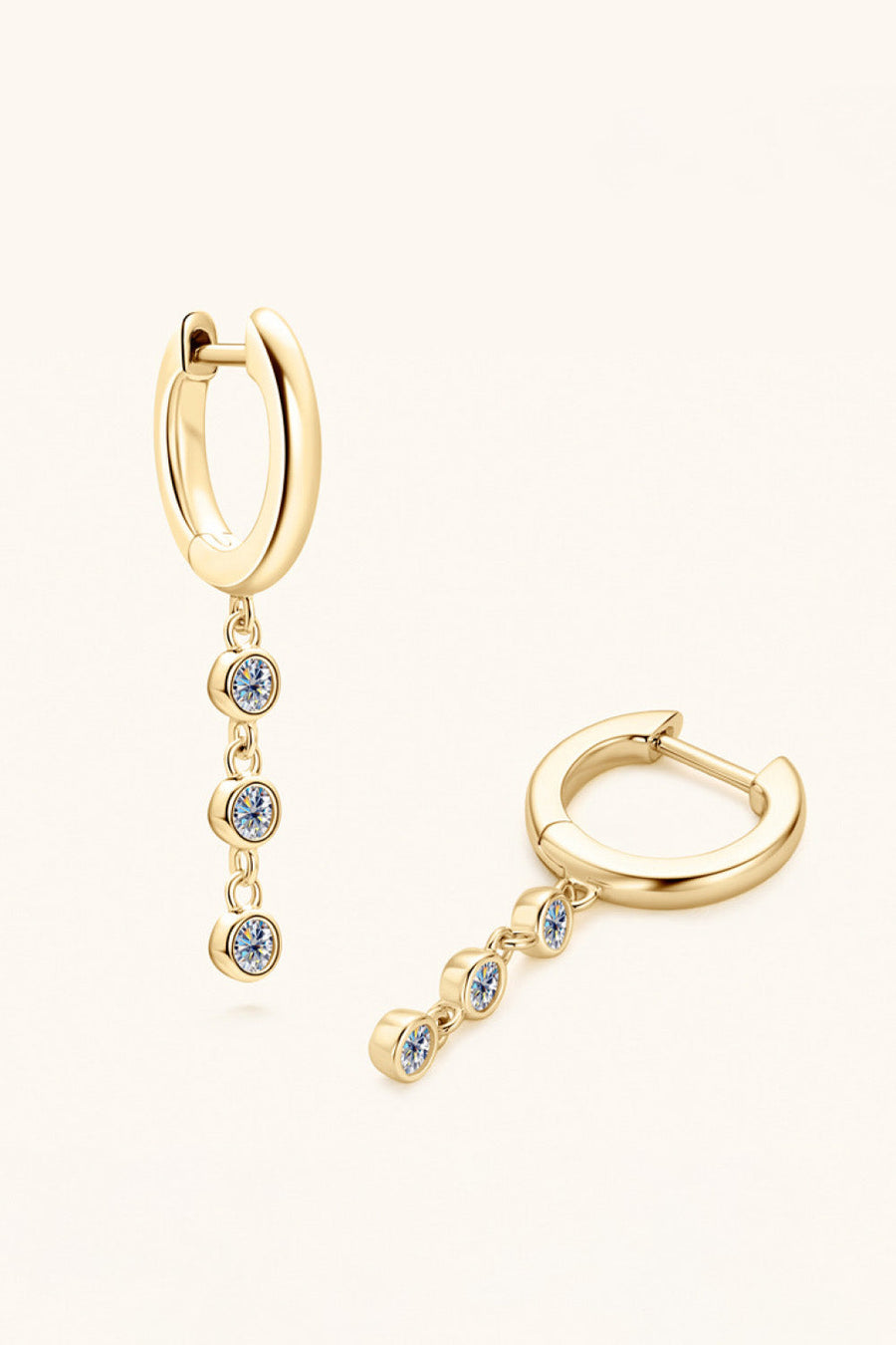 Gold dangling gemstone sterling hoop earrings with three clear stones each.