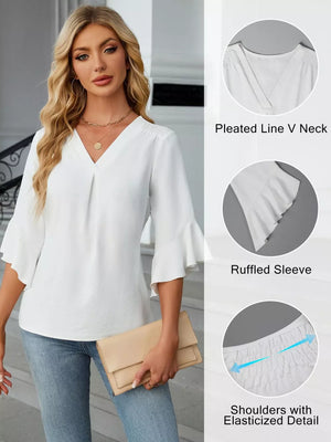 White V-neck blouse with ruffled sleeves and elasticized shoulders.