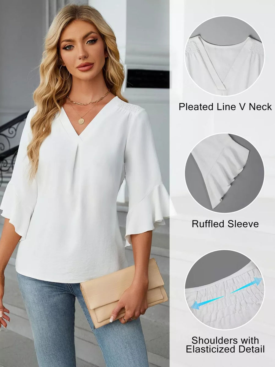 White V-neck blouse with ruffled sleeves and elasticized shoulders.