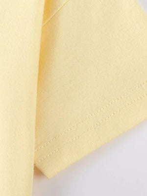 Yellow cotton t-shirt sleeve with double-stitched hem detail