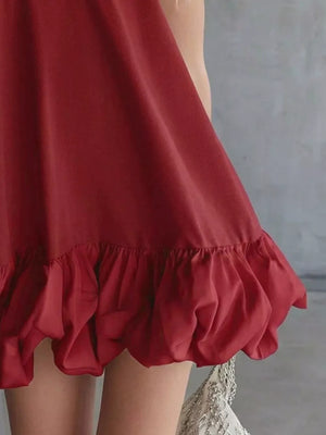 Burgundy V-neck mini dress with bubble hem and ruffled detail.