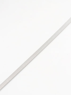 Silver metal mesh belt with a ribbed texture, styled as a waist accessory.