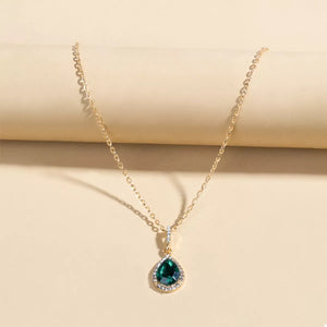 Elegant teardrop pendant necklace with dark green crystal and 18K gold-plated chain.