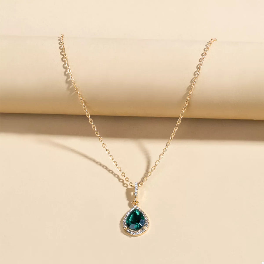 Elegant teardrop pendant necklace with dark green crystal and 18K gold-plated chain.