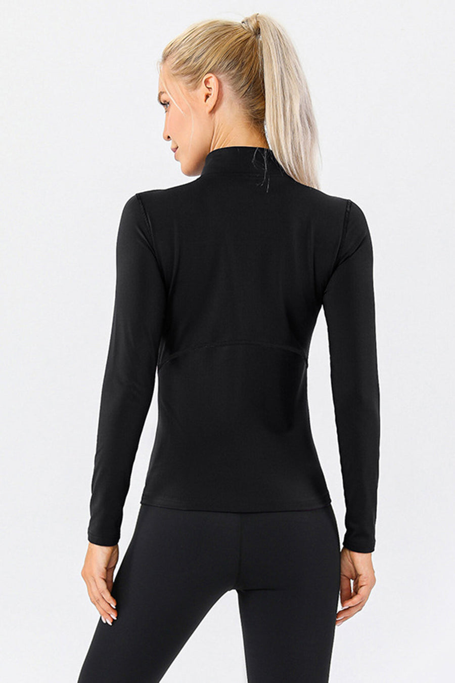 Black athleisure zip-neck top with long sleeves and seam details.