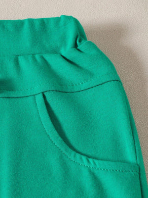 Green baby set with elastic waistband and functional pocket detail
