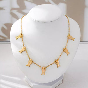 Gold necklace featuring charm details and fish motif