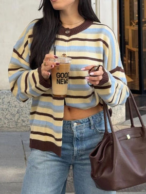cream cardigan featuring buttoned and striped