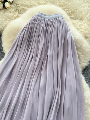 Pleated maxi skirt in light purple with a satin waistband.