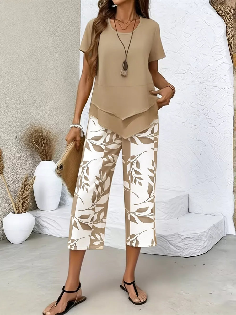 Two-piece set with tan short-sleeve layered top and cropped pants with leaf print