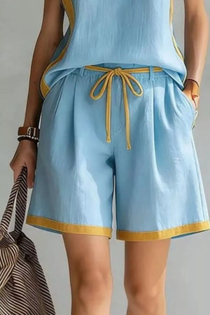 Light blue tank and shorts set with yellow contrast trim and drawstring waist.