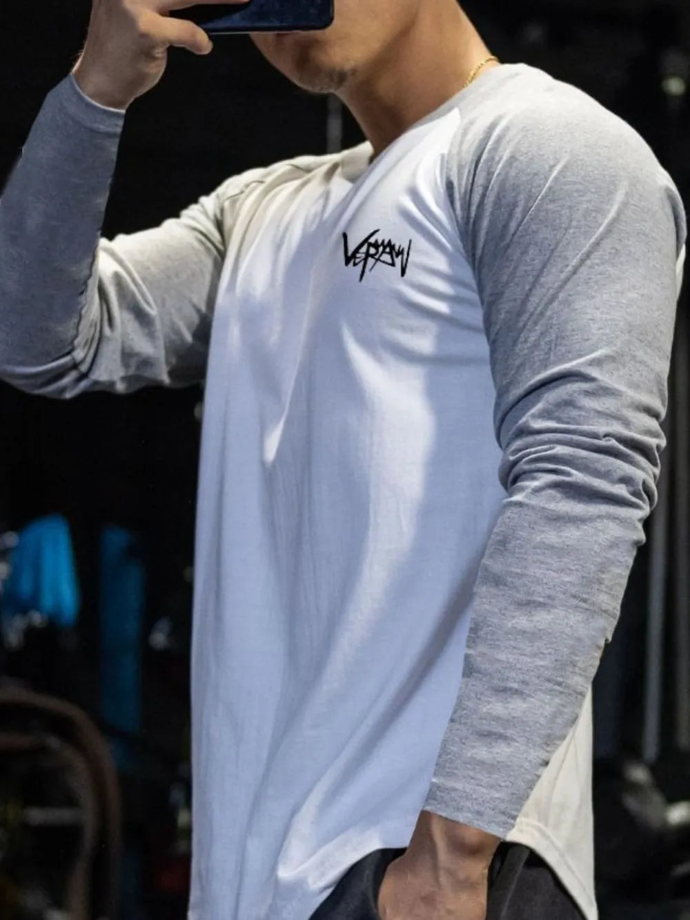 Raglan sleeve graphic tee in white with gray sleeves and black logo.