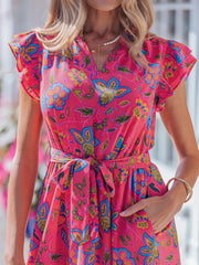 Floral midi dress with ruffled sleeves, V-neck, and belted waist in a cotton blend.