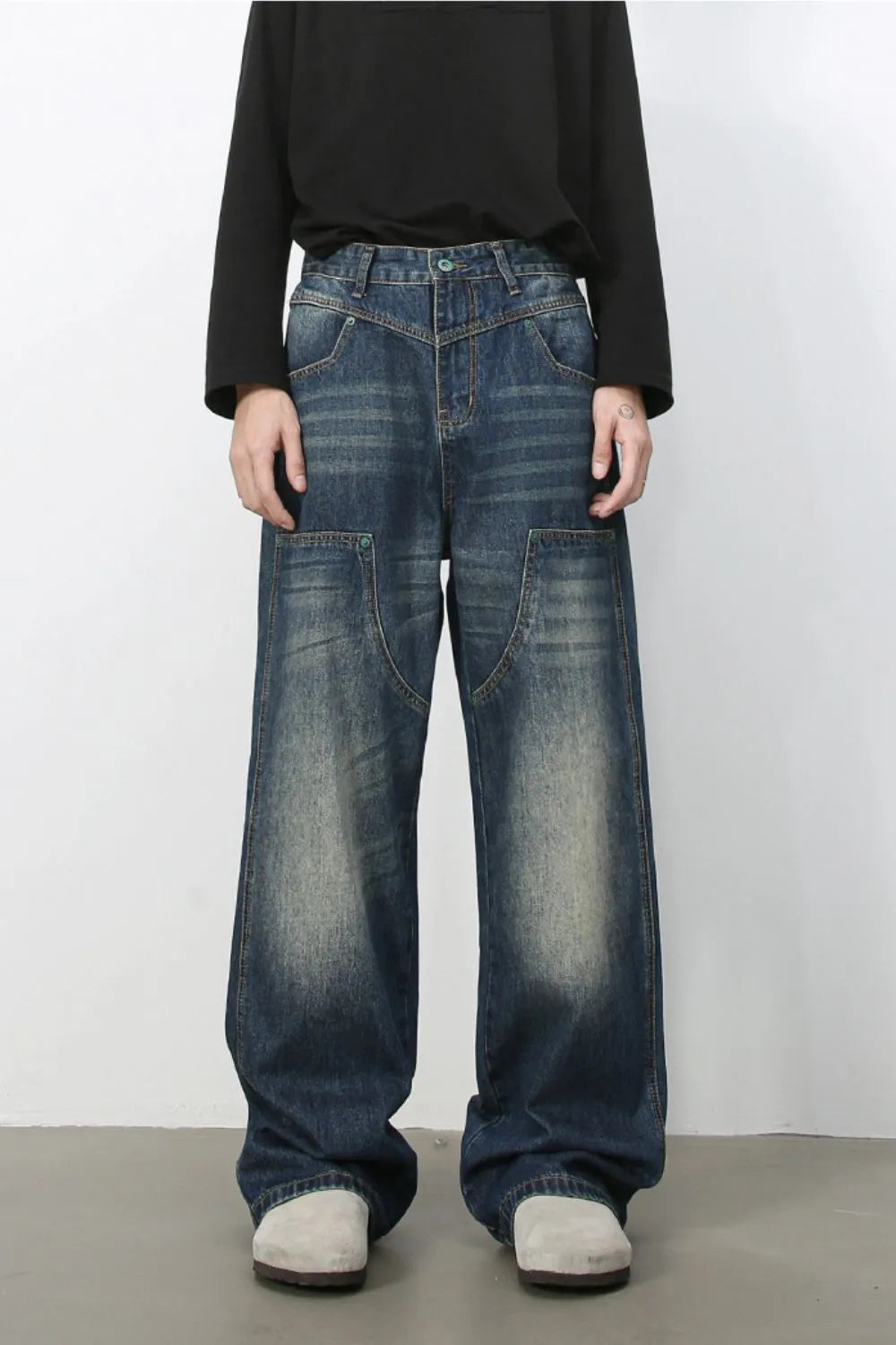 Artisan distressed wide-leg jeans in medium wash denim with unique pocket details.