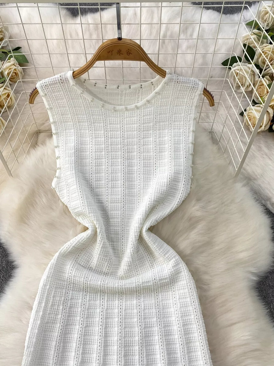 White knit midi dress with pearl trim and cutout details