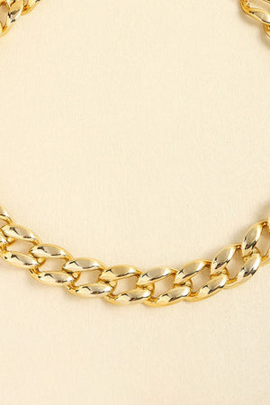 Chunky gold-tone curb chain necklace with large, polished links.