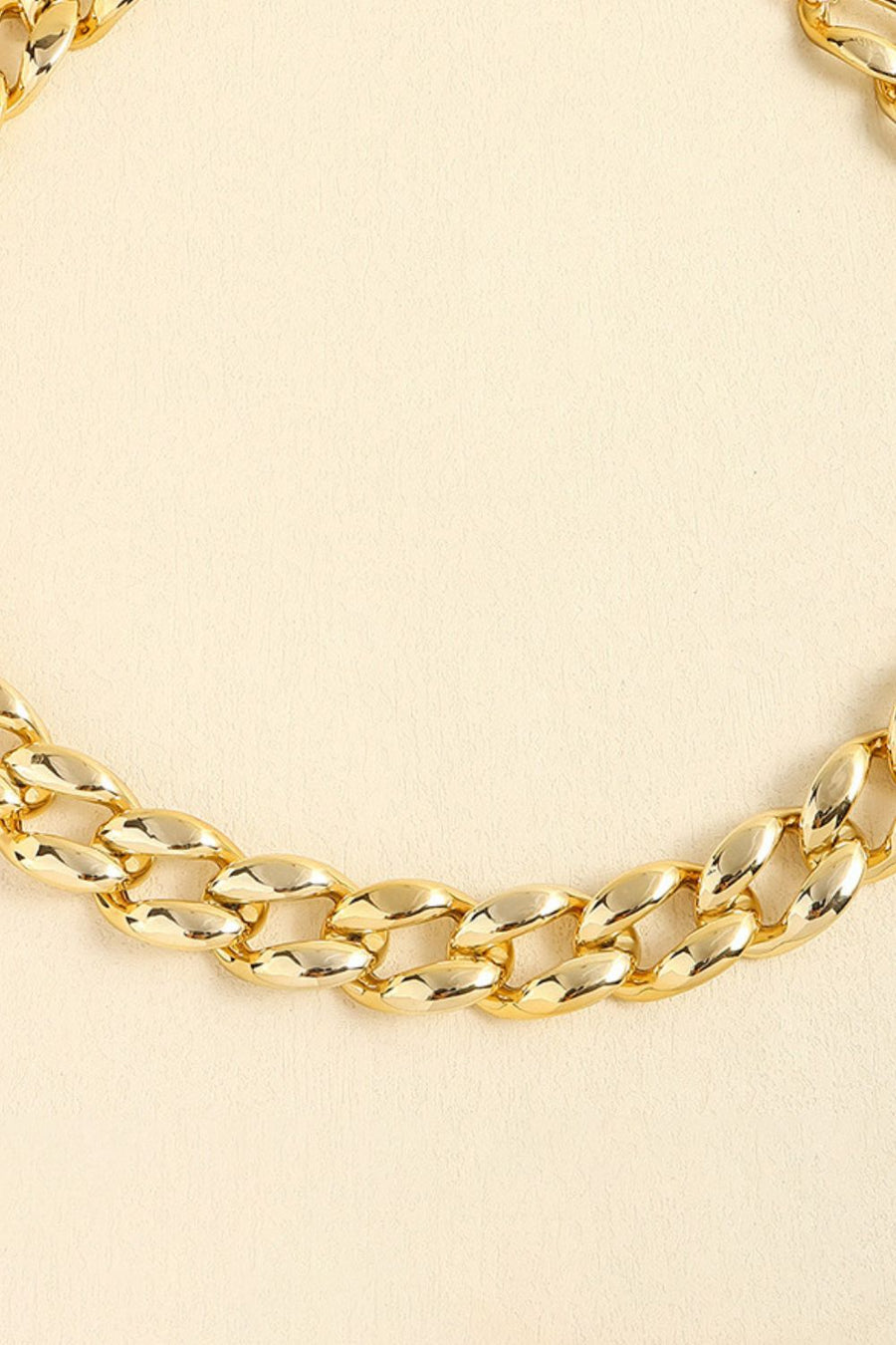 Chunky gold-tone curb chain necklace with large, polished links.
