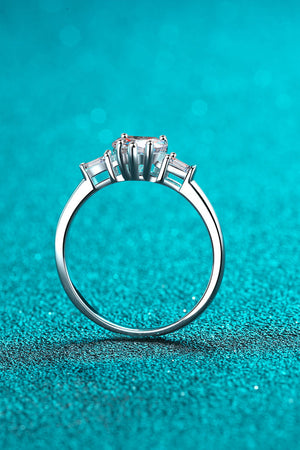 Silver ring with heart-cut moissanite and baguette side stones