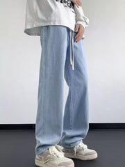 Light blue oversized drawstring jeans with a loose fit and white drawstring.