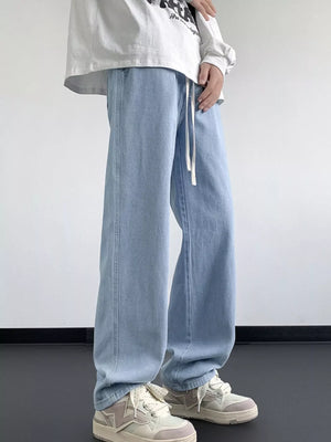 Light blue oversized drawstring jeans with a loose fit and white drawstring.