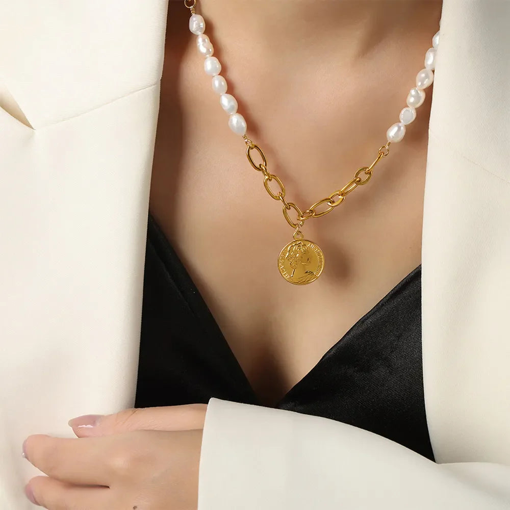 Gold pearl and coin link necklace with baroque pearls and a coin pendant.