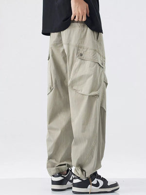 Khaki loose fit cargo pants with multiple pockets and drawstring detail.