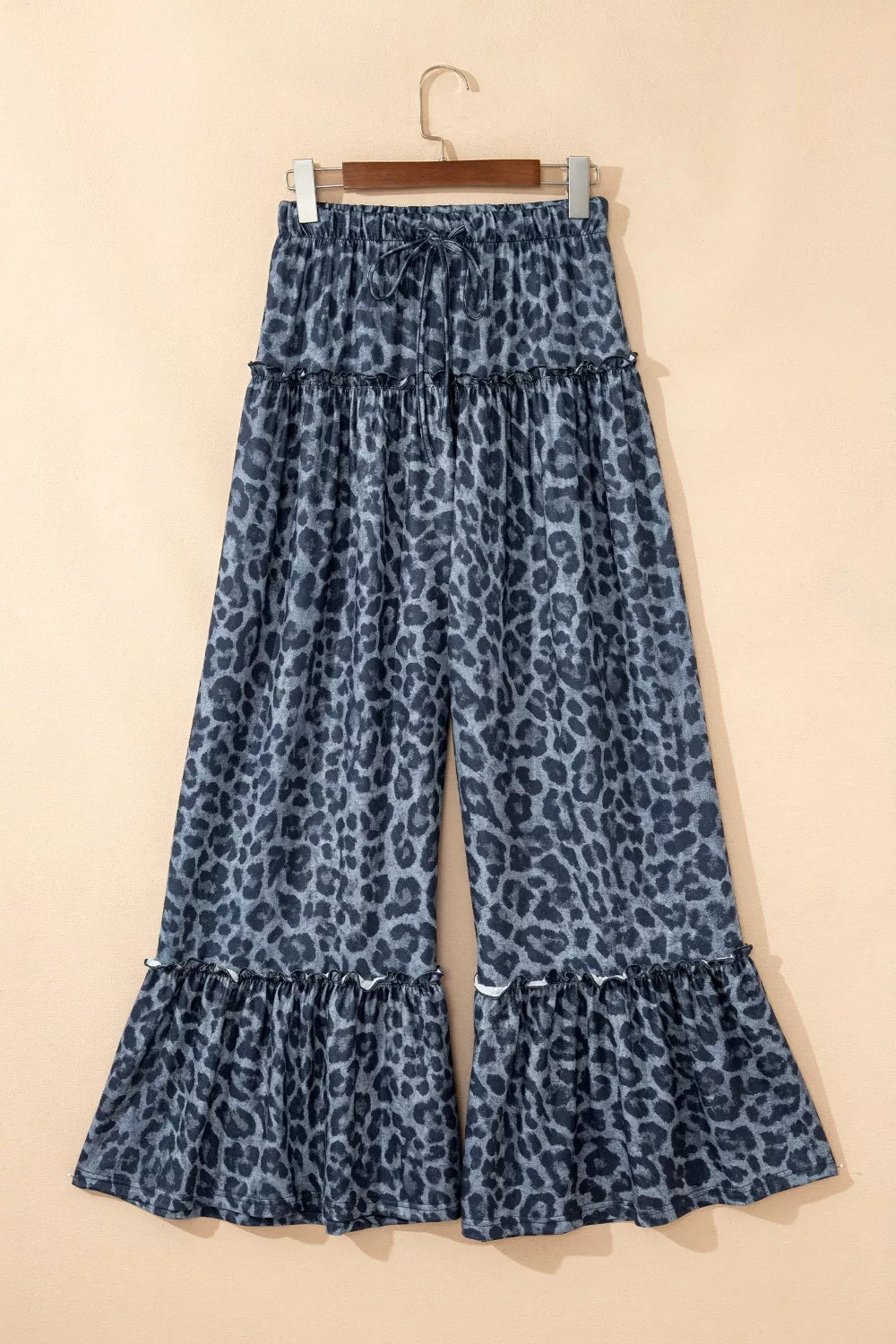 Maternity leopard print wide-leg pants in dark navy with ruffled tiers and a drawstring waist.