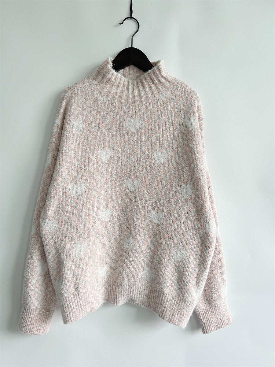 Blush pink acrylic turtleneck sweater with a subtle heart motif pattern.