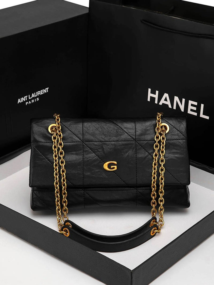 black shoulder bag with flap and geometric