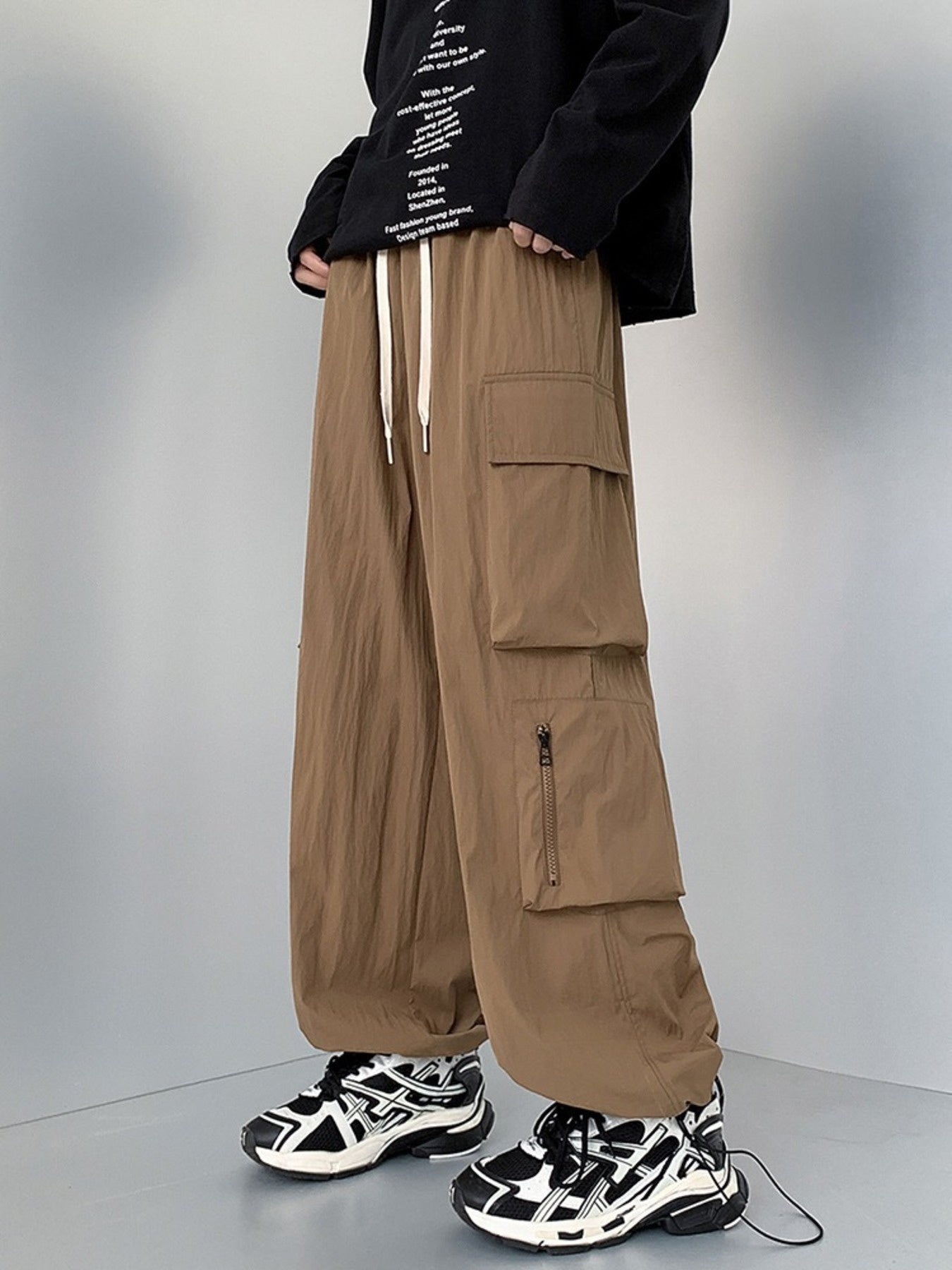 Men's camel cargo sweatpants with drawstring and multiple pockets.