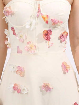 Cream tulle maxi dress with floral appliques and sweetheart neckline.