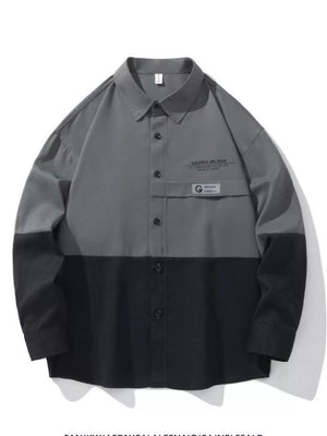 Oversized casual button-down shirt in color-block grey and black with chest pocket detail.