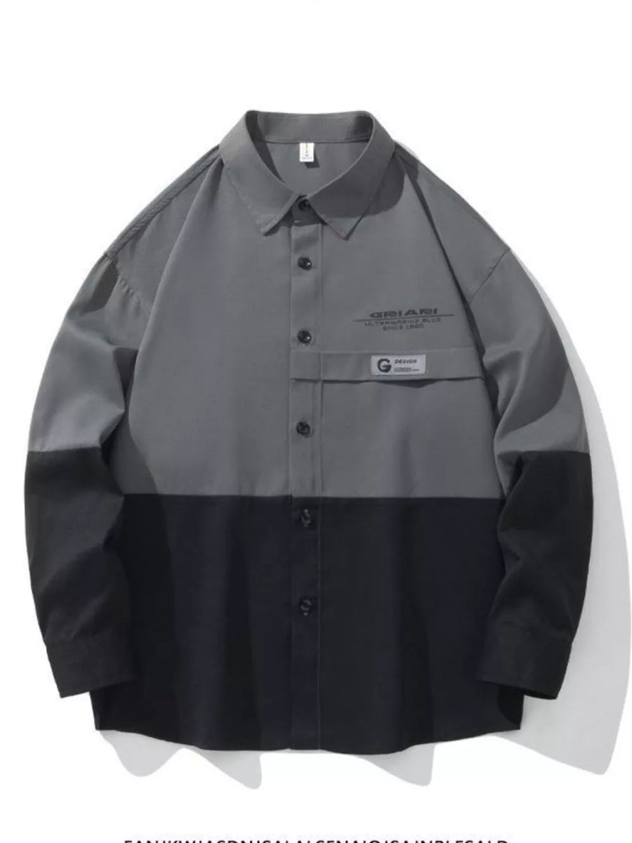 Oversized casual button-down shirt in color-block grey and black with chest pocket detail.
