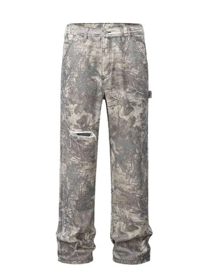 Distressed camo carpenter jeans in gray with a ripped knee detail.