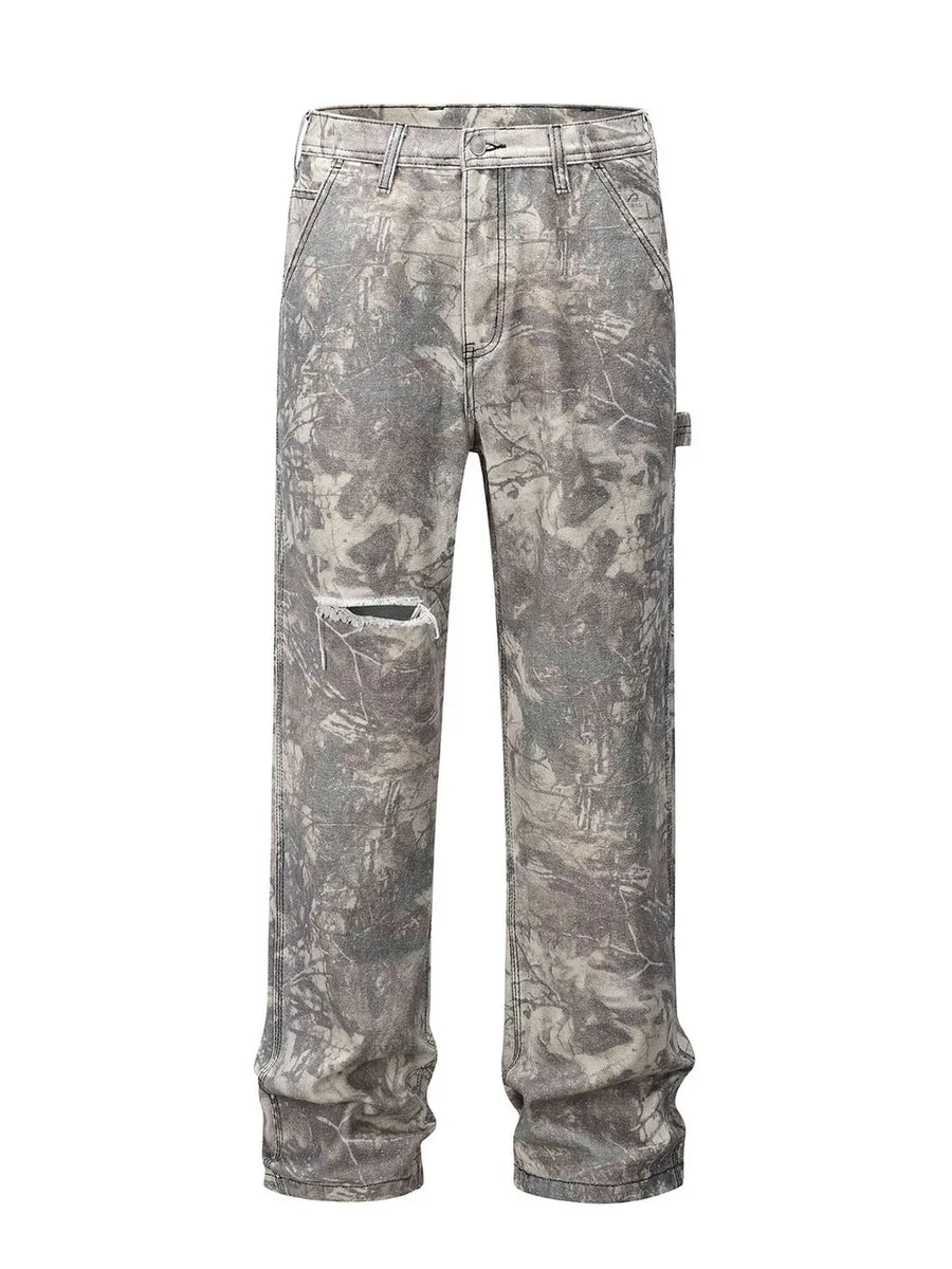 Distressed camo carpenter jeans in gray with a ripped knee detail.