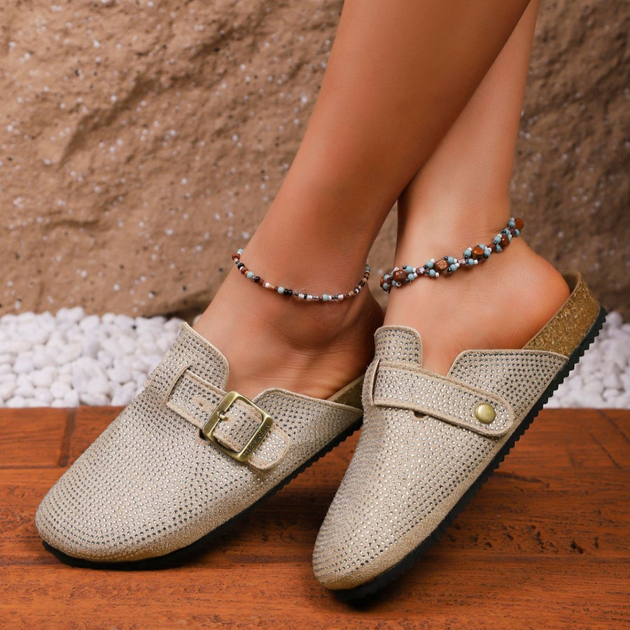 Khaki rhinestone buckle slip-on mules with cork sole detail.