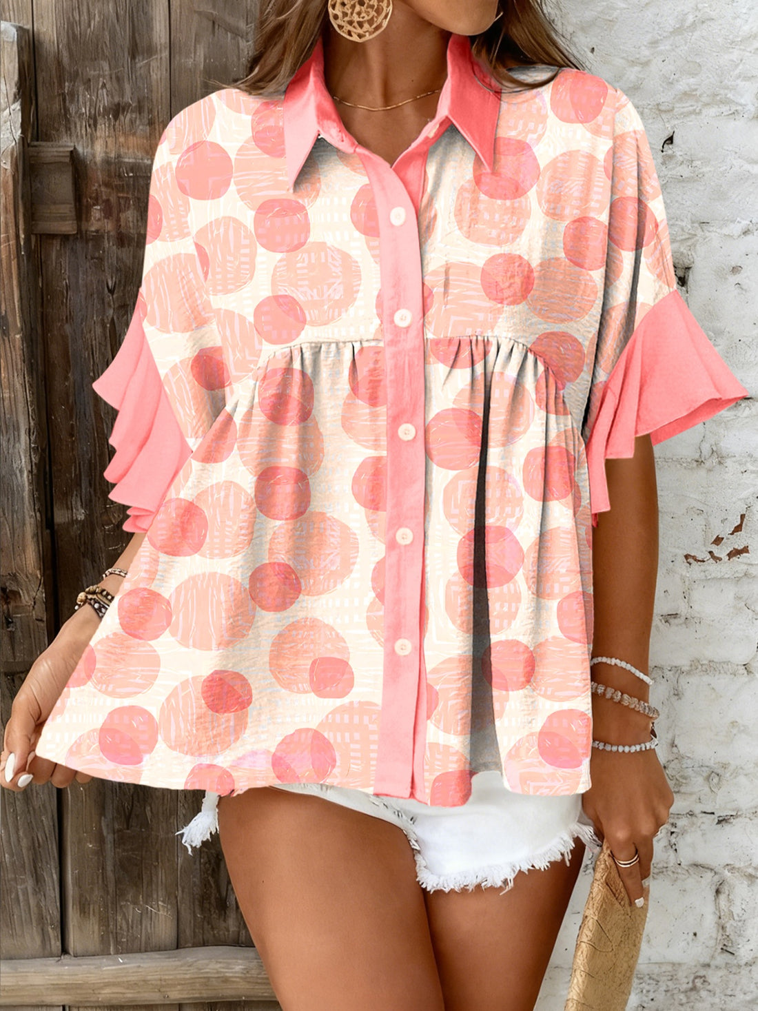 Polka dot babydoll blouse with ruffle sleeves and button front.