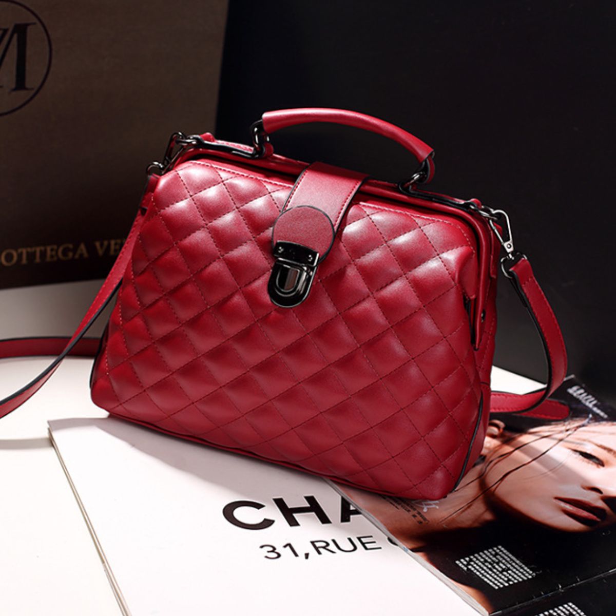 crossbody bag in burgundy featuring quilted and structured fit