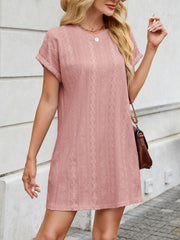 Dusty pink eyelet mini dress with diamond pattern, crew neck, and short sleeves.