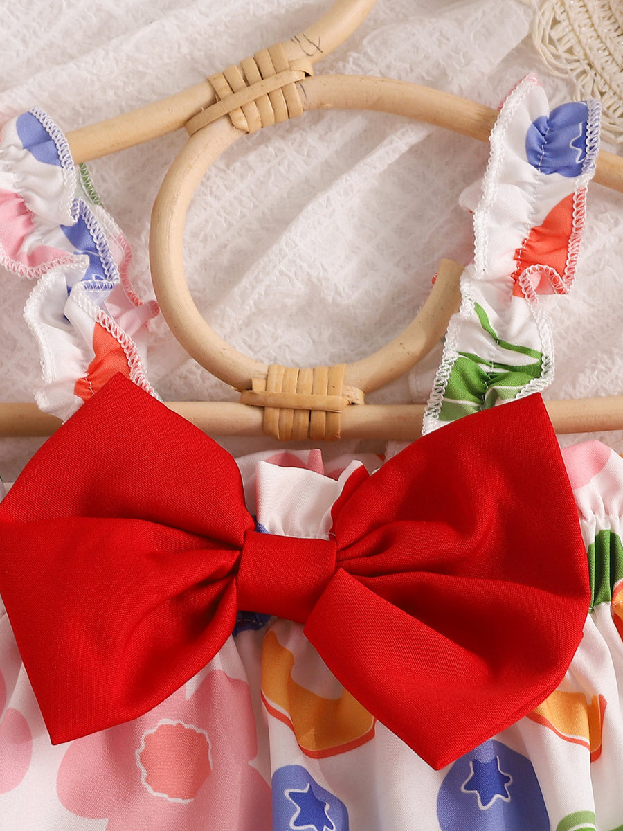 Fruit print bikini set with red bow detail and ruffled straps.