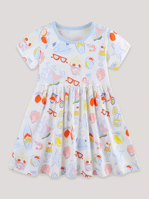 White cotton a-line toddler dress with playful summer print, short sleeves, and blue trim.