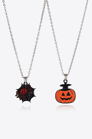 Spooky season necklaces with spiderweb and jack-o-lantern enamel pendants on silver chains.