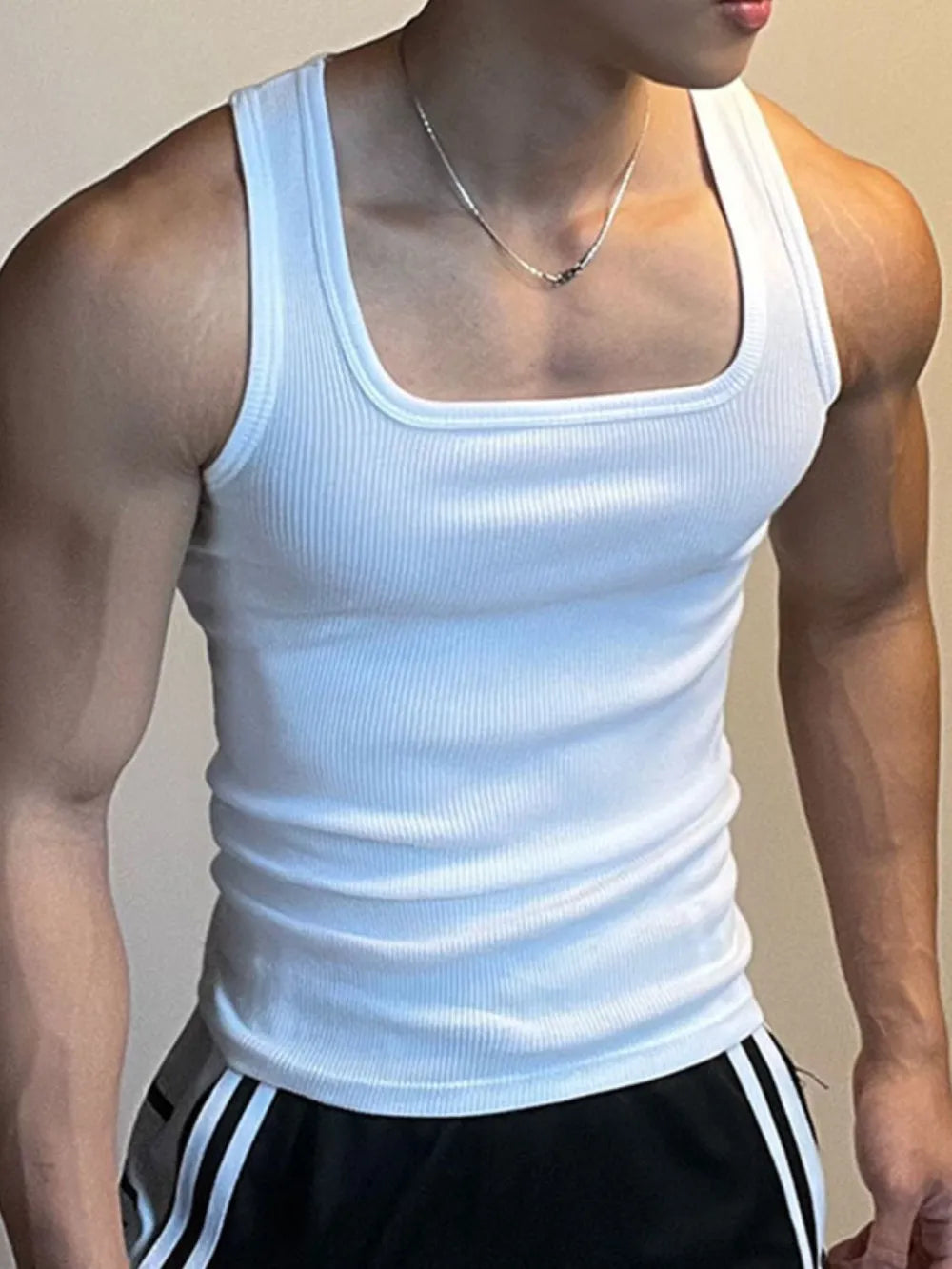 White ribbed tank top with square neckline and wide straps.