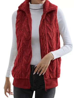 Red faux fur zip-up vest with chevron texture and stand-up collar.