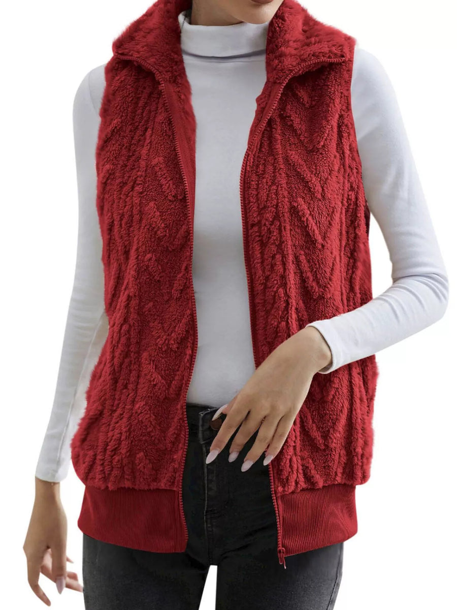 Red faux fur zip-up vest with chevron texture and stand-up collar.